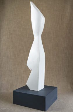 Wood carving sculpture of abstract figure painted white on a grey wood base