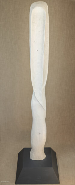 Tall narrow wood carved sculpture of abstract figure with curved edges painted white with grey wood base